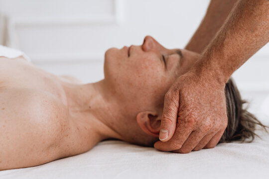 Man receiving professional head and neck massage for relaxation