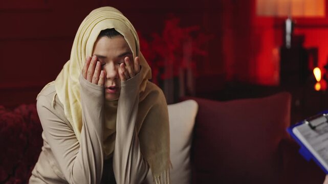 Depressed Muslim woman sharing problems with counselor, seeking support