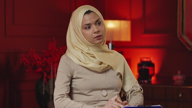 Professional Muslim psychologist consulting patient and offering advice