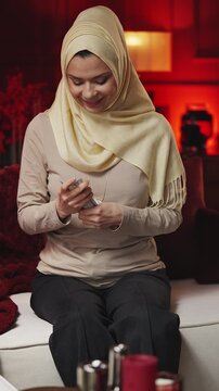 Young Middle Eastern woman counting money, saving for dream purchase