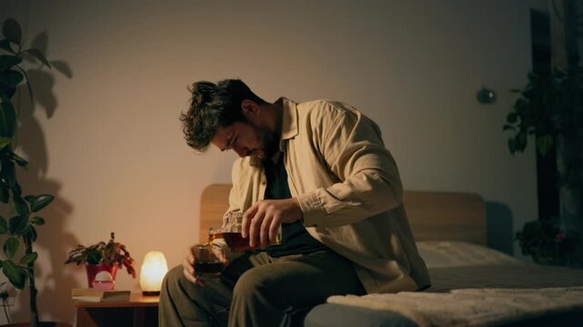 Substance abuse and depression cause troubled adult man to sit on bed. Severe psychological pain