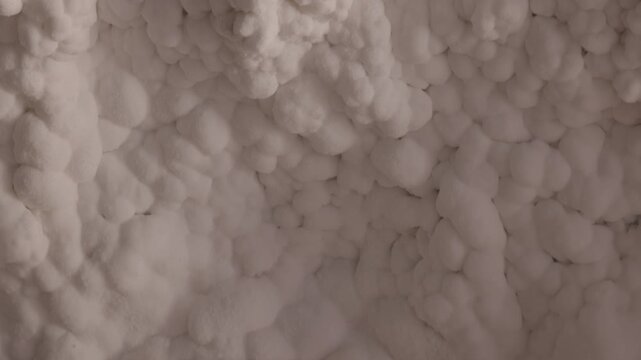 The salt cave walls on Qeshm Island feature textured mineral and crystalline salt formations. Close-up view of natural geological patterns and underground deposits. ProRes 422, 10-bit, C-Log video..