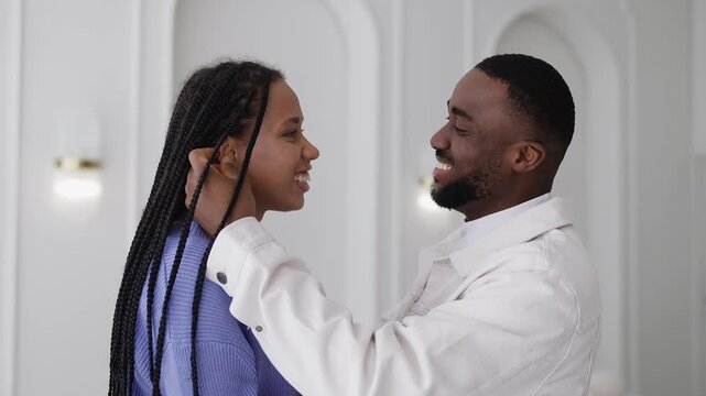 Young African American couple hugging and smiling, showing close relationship