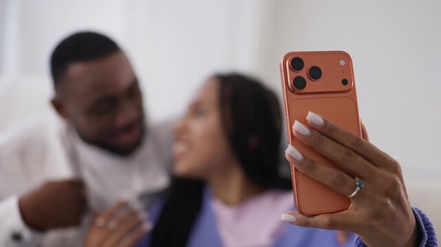 Happy African American couple making video call on phone using mobile app