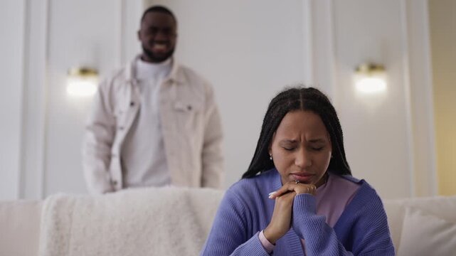 Angry Black man yells at sad girlfriend, emotional abuse and relationship crisis