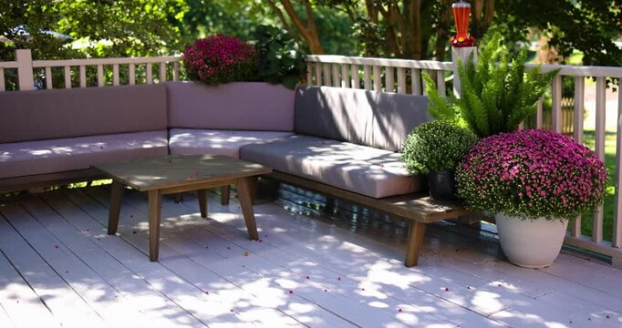 Inviting Backyard Deck with Outdoor Sectional Sofa and Blooming Fall Flowers