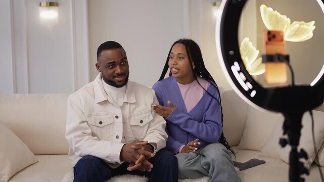 Young African American couple record lifestyle video for their blog at home