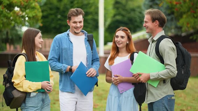 Group of university students talking in campus park