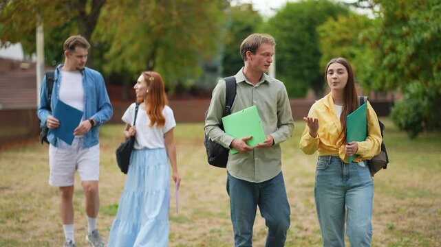 University students walking and talking on campus