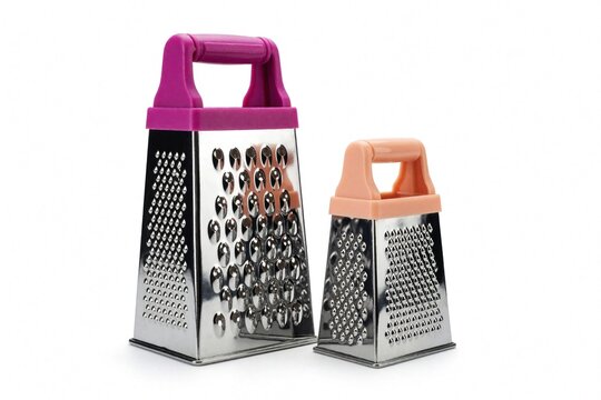 Two stainless steel graters with colorful plastic handles sit on white background. Large purple kitchen tool, small peach shredder stand together. Metal food slicers for cheese, vegetables chocolate