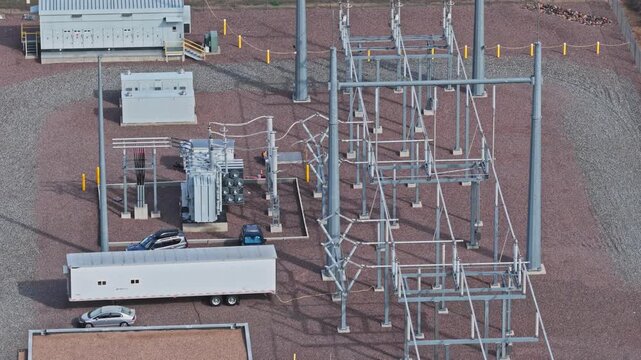 Overhead close view of an industrial electrical substation with transformers and transmission lines drone video arvada colorado 4K