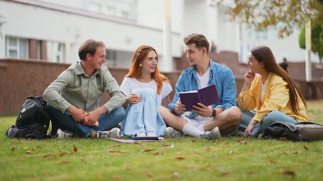 University students studying together on campus lawn