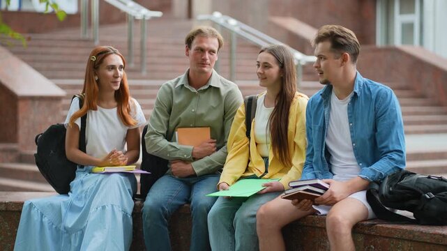 Group of college students talking on campus stairs