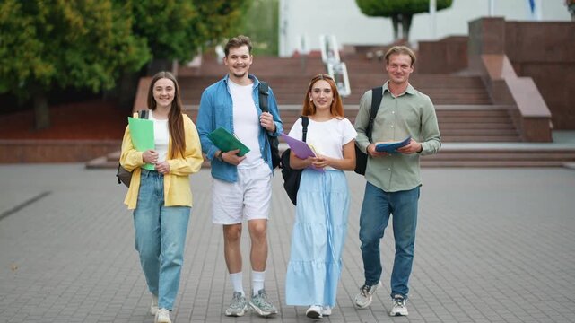 Happy university students walking together on campus