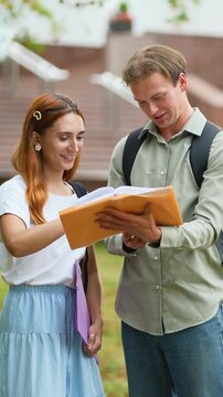 University students studying together on campus lawn