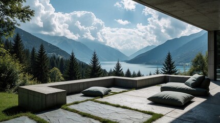 Fototapeta premium Modern concrete terrace with comfortable cushions offers stunning mountain lake views. Minimalist outdoor seating overlooks blue water, pine forest. Peaceful landscape with high peaks, white clouds