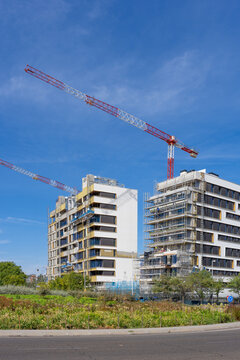 Construction site with modern buildings and cranes in Madrid, Spain