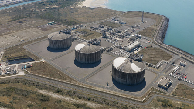 Aerial view of the Dunkirk LNG Terminal featuring large storage tanks and industrial facilities located along the coast in Loon-Plage, Hauts-de-France, France.