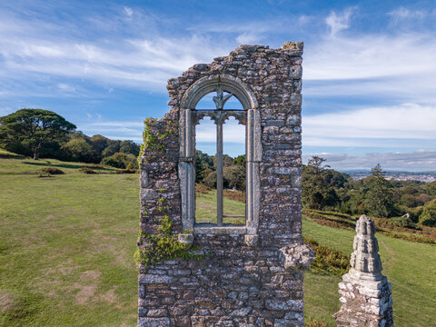 Aerial view of the historic Folly ruin stone structure at Mount Edgcumbe set in lush parkland in Cremyll, England, United Kingdom.