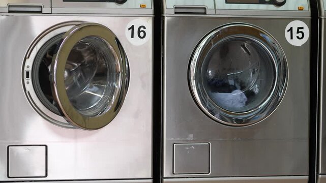 Commercial Stainless Steel Washing Machines Row with Open Door in Public Self Service Laundromat Modern Household Cleaning Equipment Concept