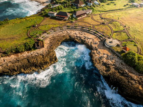 Aerial view of Devil's Tears on Nusa Lembongan, featuring dramatic rocky cliffs, crashing turquoise waves, and coastal landscape in Klungkung Regency, Bali, Indonesia.
