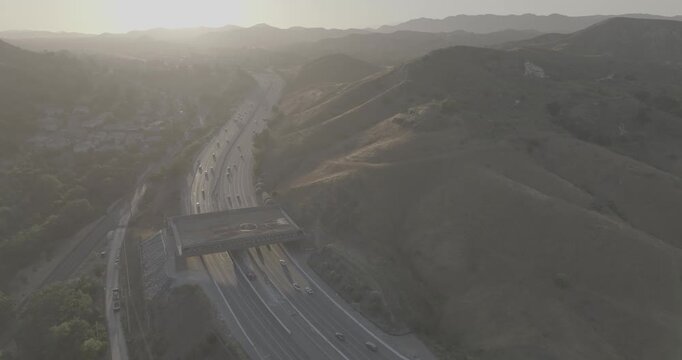 Orbiting Aerial of Hills and Wildlife Crossing at Golden Hour