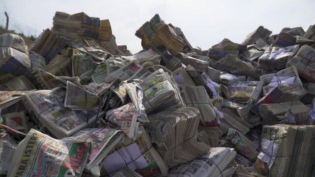 Industrial recycling factory processing scrap waste paper and old newspapers on automated conveyor belt