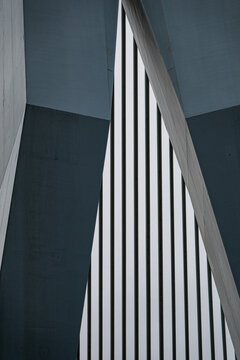 View of abstract modern architectural details featuring sharp concrete angles and vertical metal slats in Rotterdam, South Holland, Netherlands.