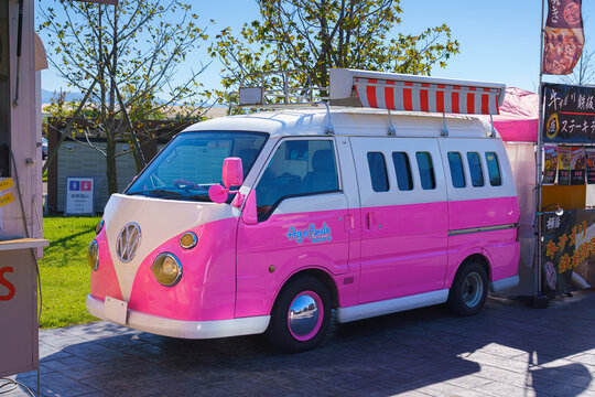 Yatsushiro, Kumamoto Pref, Japan - Oct 9 2024, close-up view of a parked kei car decorated like a pink Volkswagen minivan, without people, at daytime, Yatsushiro, Japan