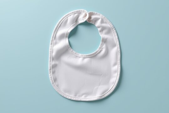 White baby bib on blue background, minimal and clean design