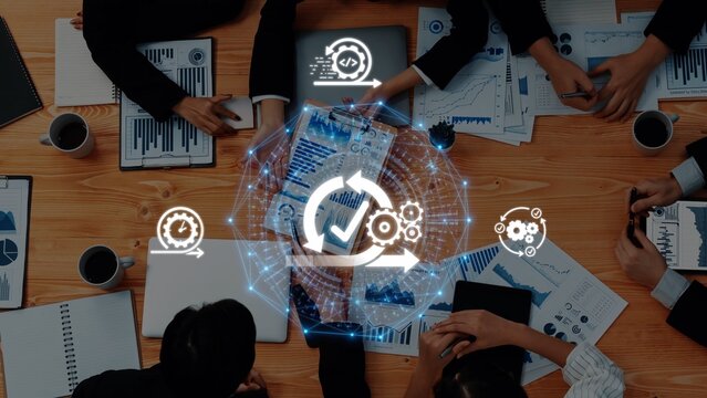 Diverse business team collaborating on project analysis, showcasing data and automation concepts in a modern office environment, emphasizing teamwork and innovation. Raster