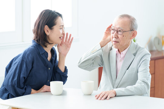難聴の高齢者に大声で話をする女性