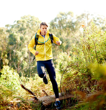 Nature, running and man on mountain for hiking with fitness, exercise or training on trail. Sports, outdoor and male person trekking for cardio workout with health, activity or hobby with backpack.