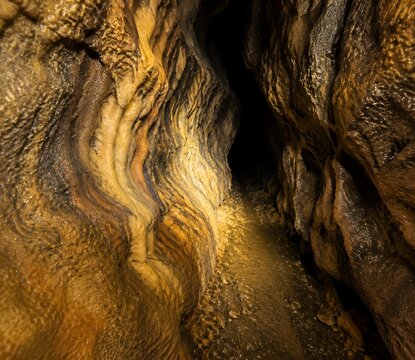 Tight cave squeeze with headlamp glow