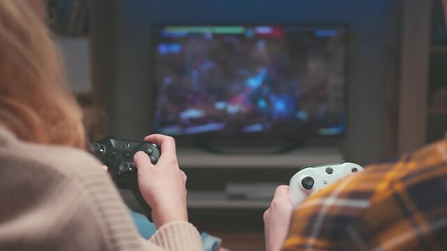 Closeup of Unrecognizable Man Holding White Gamepad during Video Game Session. Male Hand Use Controller while Woman Sits Next with Black Device. Couples Home Leisure and Electronic Technology 4k