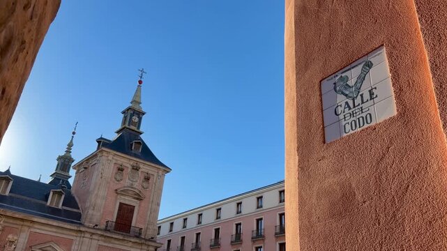 Sunny day view of the historic Plaza de la Villa, with the Casa de la Villa building and the typical ceramic street sign of Calle del Codo, a famous landmark in the city center of Madrid, Spain