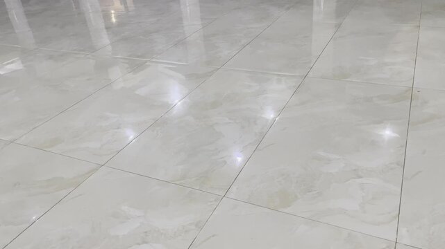 Shiny marble ceramic tile floor texture with light reflection