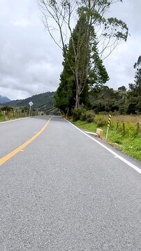 Winding Mountain Highway through Misty Highlands Seen from a Moving Car. Vehicle POV. Vertical Video.