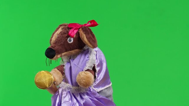 A brown plush hand puppet with a red bow and a lilac satin dress with lace collar sways and sings into a gold microphone, a playful entertainment performer setup with copy space.