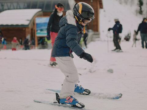 Young girl skiing together down a slope during a ski lesson in Chamrousse