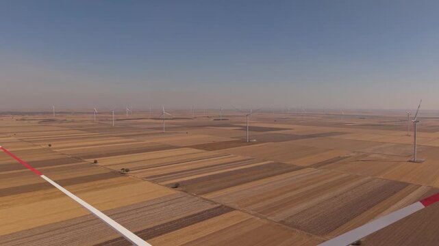 Aerial Wind Farm Panorama Across a Mosaic of Harvested Fields
