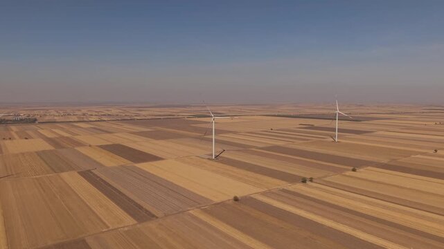 Drone Approach to Two Wind Turbines Across Striped Farmland