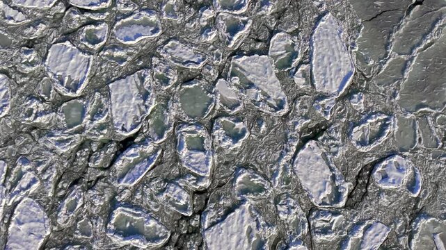 Close aerial top-down drone shot of intricate ice detail and frost patterns on a frozen sea, an abstract cold texture