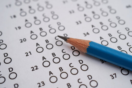 Answer sheets with pencil drawing fill to select choice, education concept.
