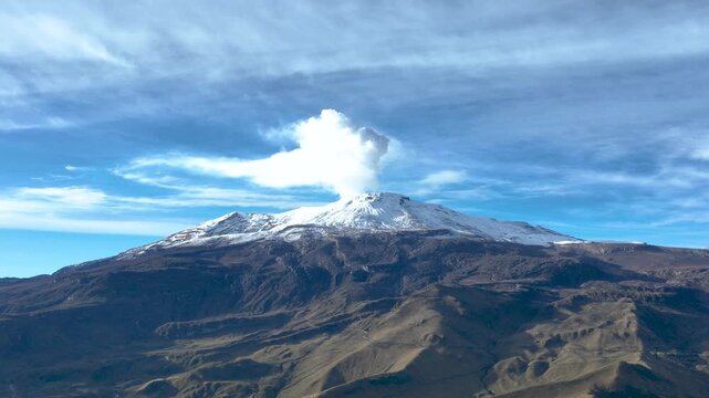 Nevado del Ruiz Active Volcano with Snow Covered Summit and Volcanic Terrain in Colombia. Aerial View.
