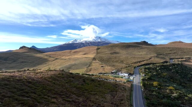Nevado del Ruiz Snowy Volcanic Summit Rising above Rugged Andean Terrain. Establishing Shot. Aerial View.