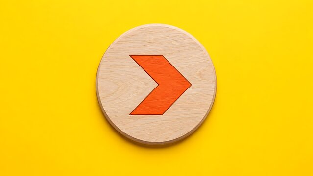 Red wooden arrow sign on a round wooden block against a yellow background representing next step business direction and navigation icon