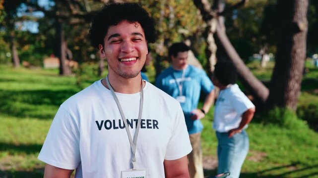 Volunteer, face or happy man with tablet in park for outdoor charity, donation or community service. Portrait, male person or NGO group with smile or technology for contribution or team outreach