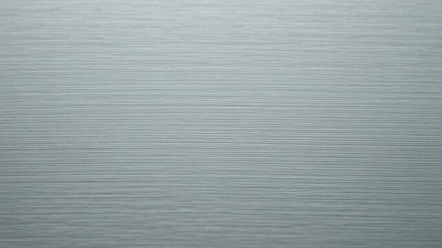 Light sweep across brushed titanium metal surface