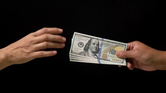 Hand refusing a bribe of hundred dollar bills